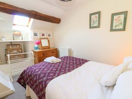 A bedroom with a bed and a chest of drawers at Chancery Cottage in Hay-On-Wye