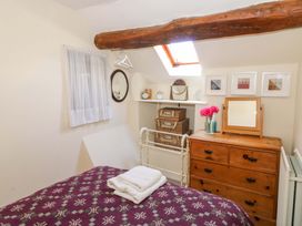 A bedroom with a bed and a dresser at Chancery Cottage Hay-On-Wye
