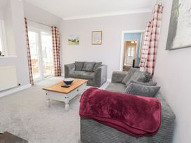 A living room with sofa and coffee table at Dyffryn Bach Glan-yr-afon near Corwen