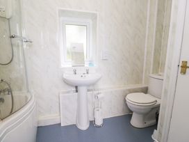 A bathroom with a shower, sink, and toilet at Dyffryn Bach in Glan-yr-afon near Corwen