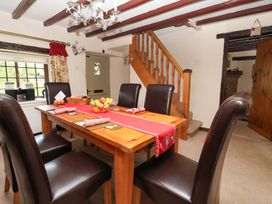 A dining room with a table and chairs at Clara's Cottage in West Lutton near Malton