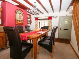 A dining room with a table and chairs at Clara's Cottage in West Lutton near Malton