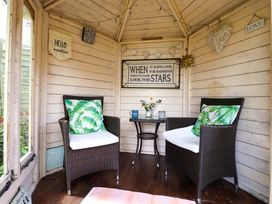 A snug with seating and decorative signs at Clara's Cottage in West Lutton near Malton