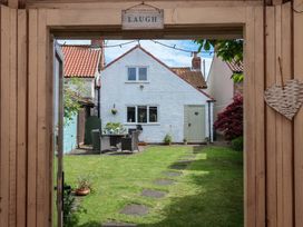 A garden view with furniture and greenery at Clara's Cottage in West Lutton near Malton