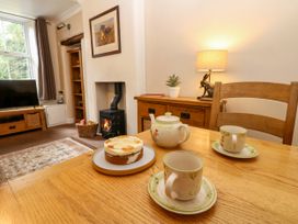 A living room with a table set for tea at 27 Bongate in Appleby-In-Westmorland