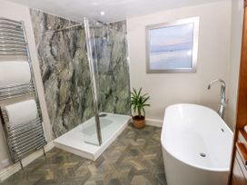 A bathroom with a shower and bathtub at 27 Bongate in Appleby-In-Westmorland