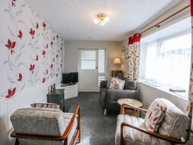 A living room with a sofa and television at Ground Floor Apartment, Tremadog