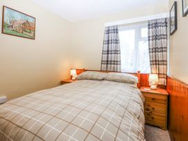 A bedroom with a bed and bedside table at Ground Floor Apartment in Tremadog