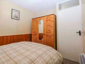A bedroom with a bed and wardrobe at Ground Floor Apartment in Tremadog
