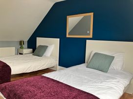 A bedroom with two beds and a lamp at Silver Birch House in Beaufort Killarney County Kerry
