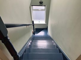A staircase with a window at Silver Birch House in Beaufort Killarney, County Kerry
