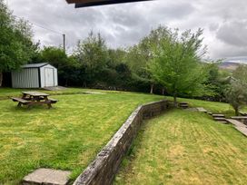 A garden with a picnic table and shed at Silver Birch House Beaufort Killarney County Kerry