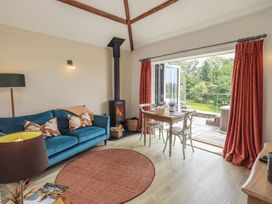 A living room with a sofa and table at Acorn in Bowness-on-Windermere