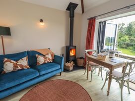 A living room with a sofa and table at Acorn in Bowness-on-Windermere