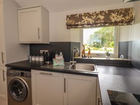 A kitchen with washing machine and sink at Acorn in Bowness-on-Windermere