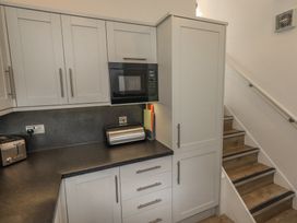 A kitchen with cabinets and appliances at Acorn in Bowness-on-Windermere