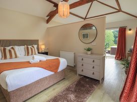 A bedroom with a bed and dresser at Acorn in Bowness-on-Windermere