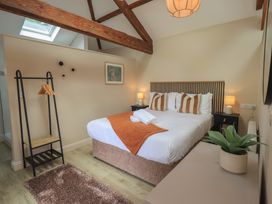 A bedroom with a double bed and wooden beams at Acorn in Bowness-on-Windermere