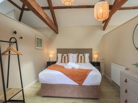 A bedroom with a bed and hanging rack at Acorn in Bowness-on-Windermere