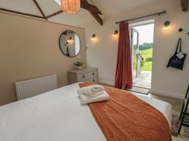 A bedroom with a bed and door leading to outdoor area at Acorn in Bowness-on-Windermere
