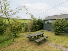 A garden with a table and benches at Ash Lodge in Pennington near Ulverston