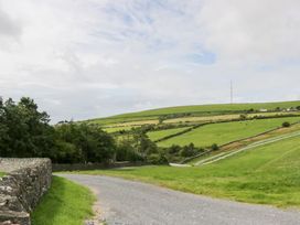 A scenic view of a rural landscape with a road and hills at Ash Lodge in Pennington near Ulverston