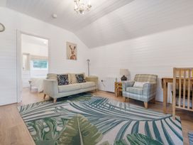A living room with sofa and armchairs at Ash Lodge Pennington near Ulverston