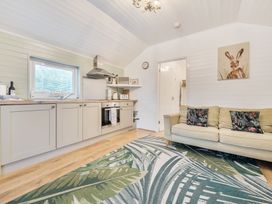 A kitchen with a sofa and a rug at Ash Lodge in Pennington near Ulverston