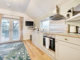 A kitchen with appliances and a television at Ash Lodge in Pennington near Ulverston