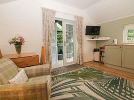 A living room with a sofa and table at Ash Lodge in Pennington near Ulverston