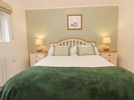 A bedroom with a bed and bedside tables at Ash Lodge Pennington near Ulverston