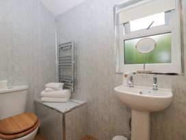 A bathroom with a toilet sink and towels at Ash Lodge in Pennington near Ulverston