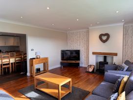 A living room with a coffee table and sofa at Rhos Helyg in Penysarn near Amlwch
