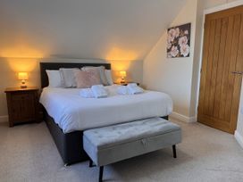 A bedroom with a bed and nightstand at Rhos Helyg Penysarn near Amlwch