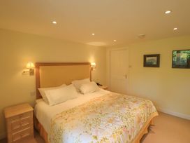 A bedroom with a bed and bedside lamps at Pheasant Cottage Beckside near Cartmel