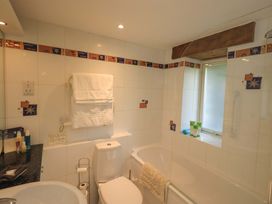 A bathroom with a toilet sink and bathtub at Pheasant Cottage near Cartmel