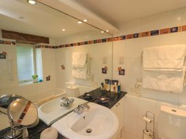 A bathroom with sink and toilet at Pheasant Cottage Beckside near Cartmel