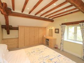 A bedroom with wardrobe and dresser at Pheasant Cottage in Beckside near Cartmel