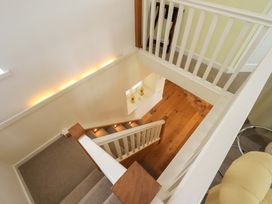 A staircase leading to the upper level at Kestrel Cottage in Beckside near Cartmel