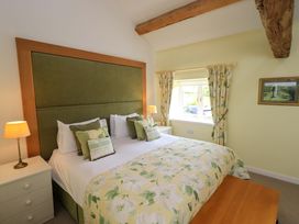 A bedroom with a bed and bedside table at Kestrel Cottage near Cartmel