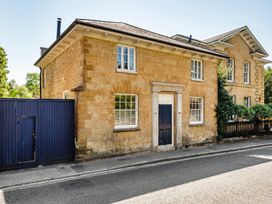 A house with a gate and stone wall at East Wing in Crewkerne