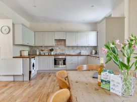 A kitchen with a table and chairs at East Wing in Crewkerne