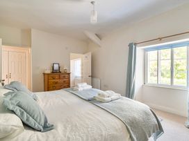 A bedroom with a bed and dresser at East Wing in Crewkerne