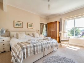 A bedroom with a bed and wardrobe at East Wing in Crewkerne