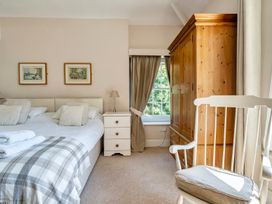 A bedroom with a bed and wardrobe at East Wing in Crewkerne