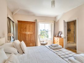 A bedroom with a bed and wardrobe at East Wing in Crewkerne