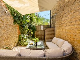An outdoor area with a seating arrangement and plants at East Wing, Crewkerne