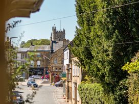 A view of a clock tower and street scene at East Wing in Crewkerne