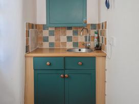 A kitchen with a sink and cabinet at The Old Workshop in Knowstone