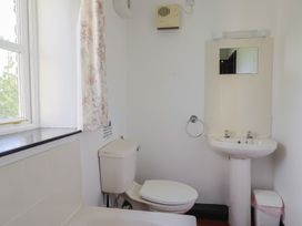 A bathroom with a sink and toilet at The Old Workshop in Knowstone